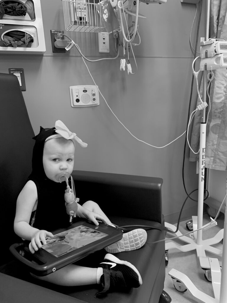 Mars plays on an iPad while receiving IV chemo.