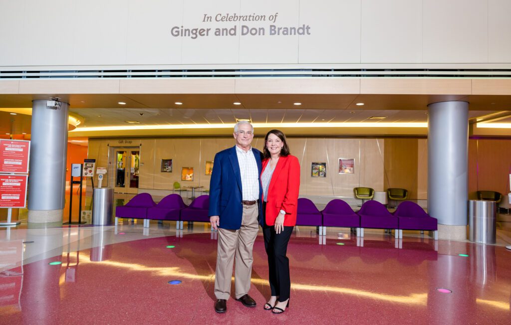 Don and Ginger pose beneath their names on the hospital wall. 