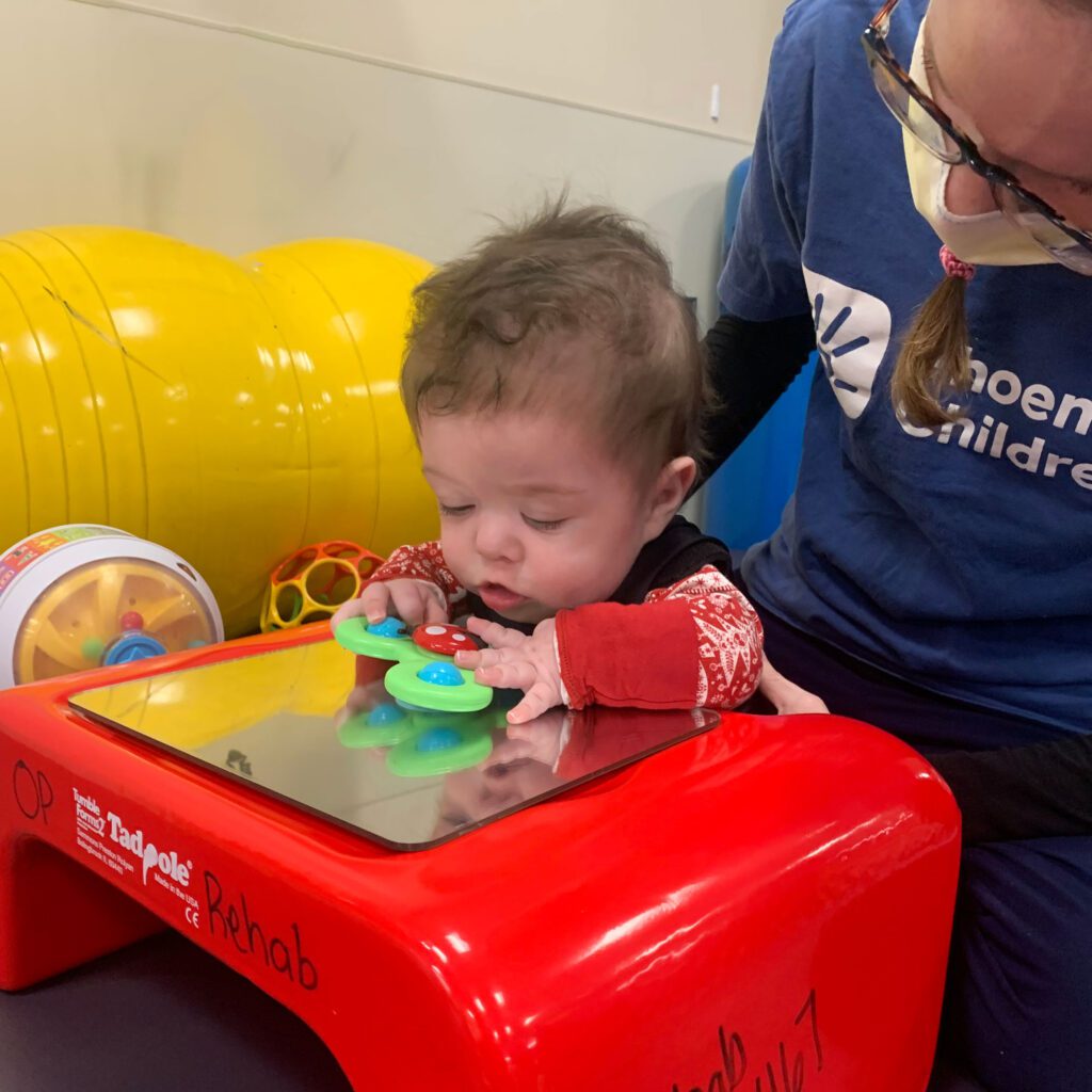 Joey plays with toys at physical therapy at Phoenix Children's