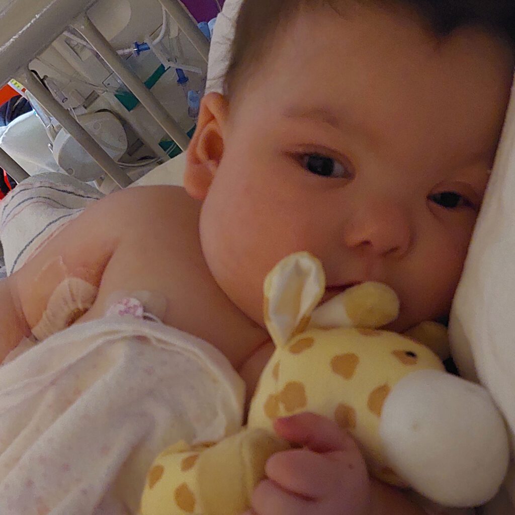 Infant Joy with her stuffed giraffe