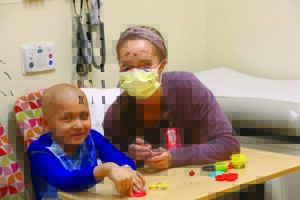 A Child Life specialist plays with a patient at the Phoenix Children's Center for Cancer and Blood Disorders.