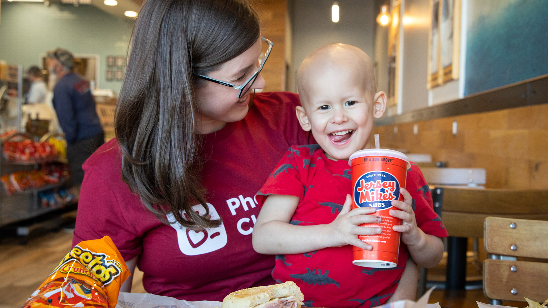 A mom and her little boy with cancer enjoy a meal together at Jersey Mike's
