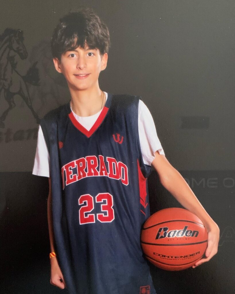 Calvin in his school basketball uniform.