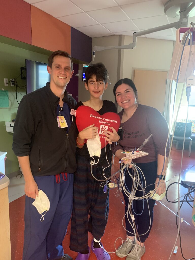 Calvin in his hospital room at Phoenix Children's with two of his caregivers.
