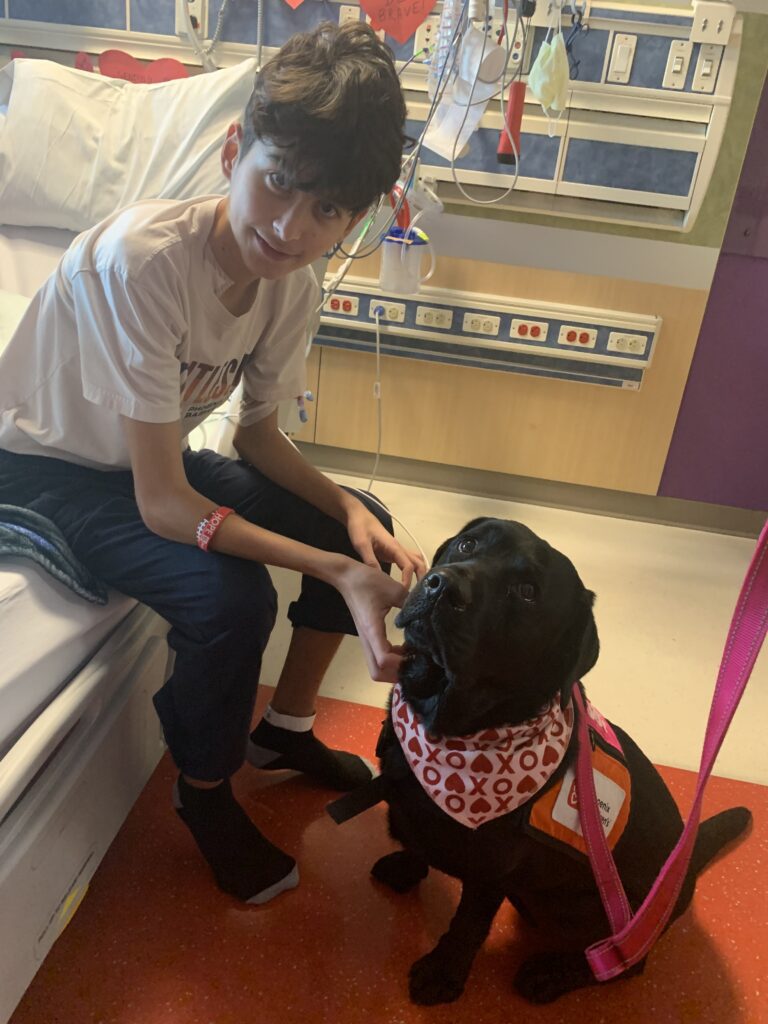 Calvin with Gertie, a Phoenix Children's therapy dog.