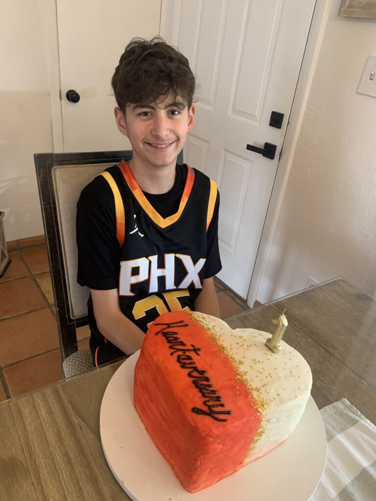 Calvin, wearing a Phoenix Suns jersey, with a heart-shaped cake that says "Heartaversary."
