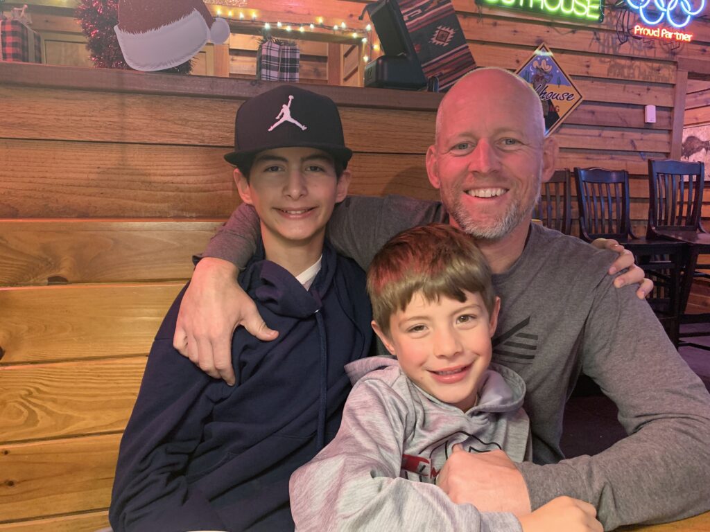 Calvin with his dad and younger brother.