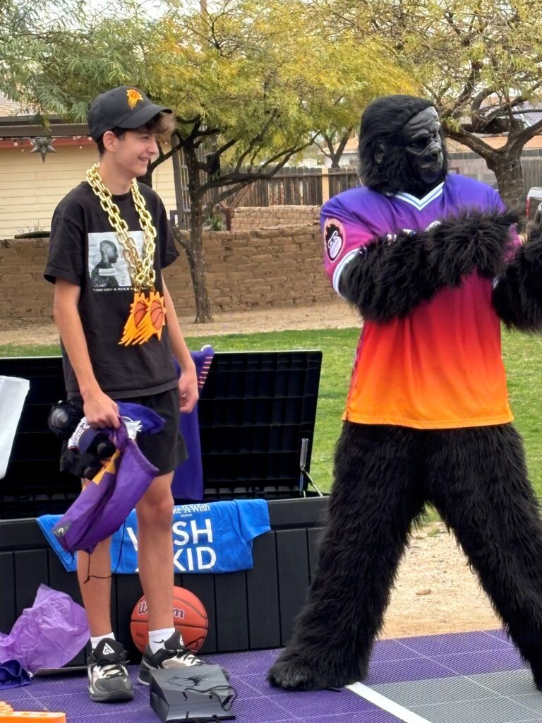 Calvin interacts with the Phoenix Suns' mascot, Go the Gorilla.