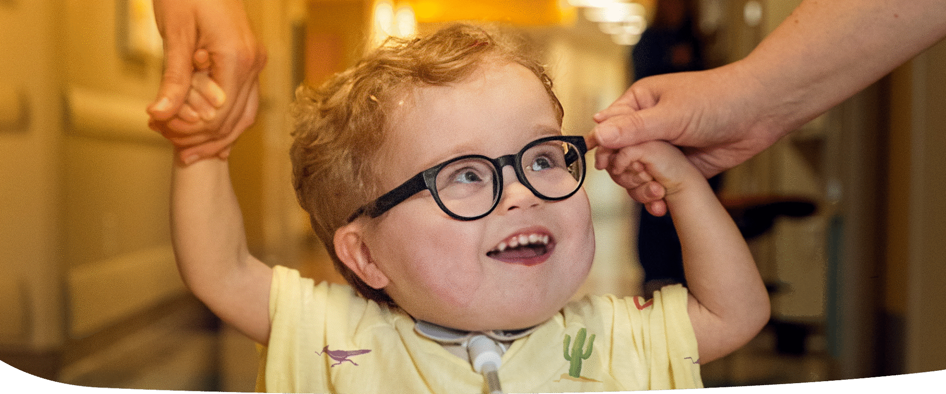 Smiling girl petting dog.