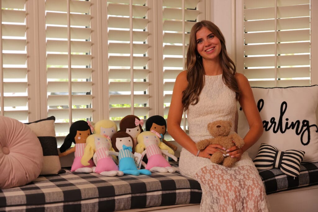 Charlotte Gould with some of the surgery companion dolls she creates for children with craniofacial conditions.